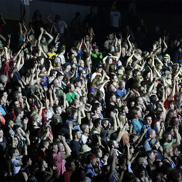 Large crowd enjoying a concert at night.