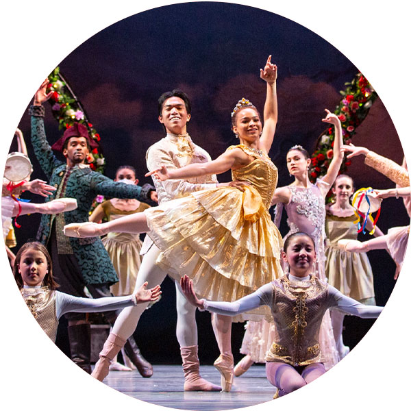 Stage full of ballet dancers in vibrant costumes